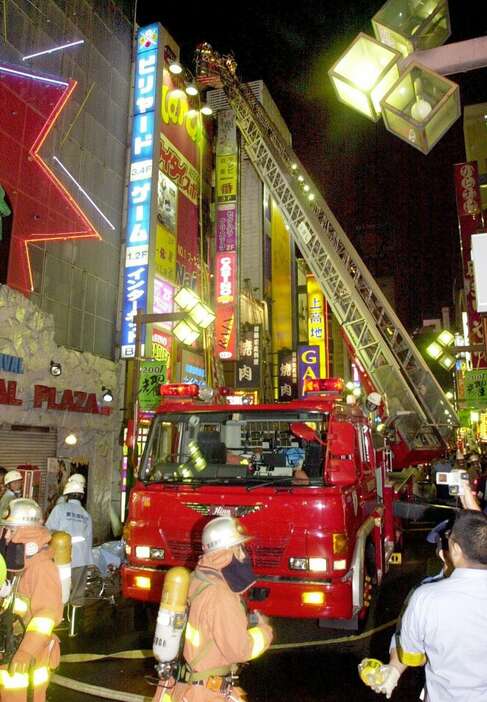 火災が起きた新宿・歌舞伎町の雑居ビルで、救助活動にあたる消防隊員ら＝平成１３年