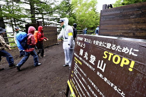 富士山での弾丸登山などを規制するため、新設されたゲートを通過する登山者ら（今年７月１日、山梨県で）