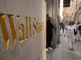 <p>A Wall Street sign near the New York Stock Exchange (NYSE) in New York, US</p>