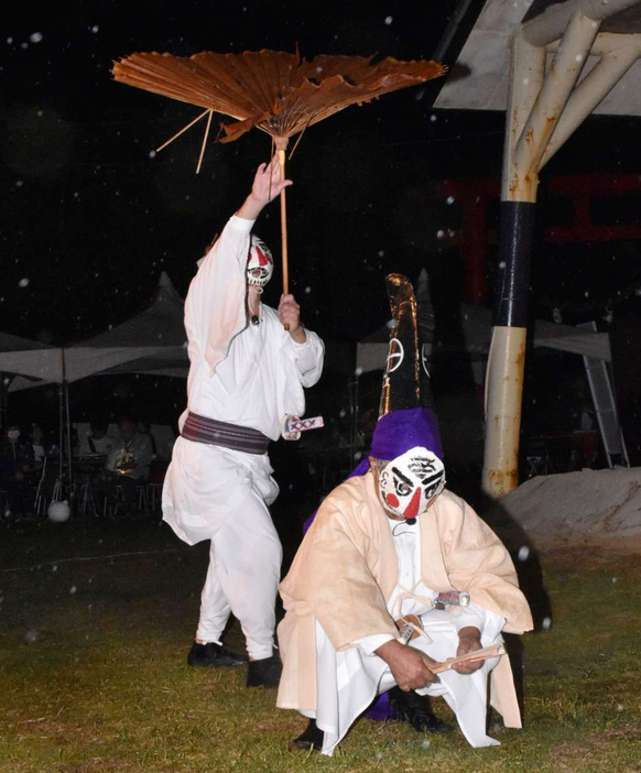 白塗りの面でコミカルな掛け合いを演じる一番組＝１５日、与論町立長の地主神社