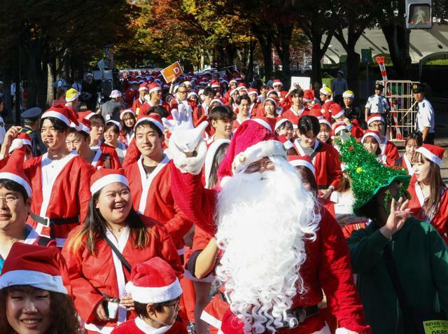 サンタクロースの姿で街を歩く参加者たち=2024年11月17日午後1時35分、東京都渋谷区、杜宇萱撮影