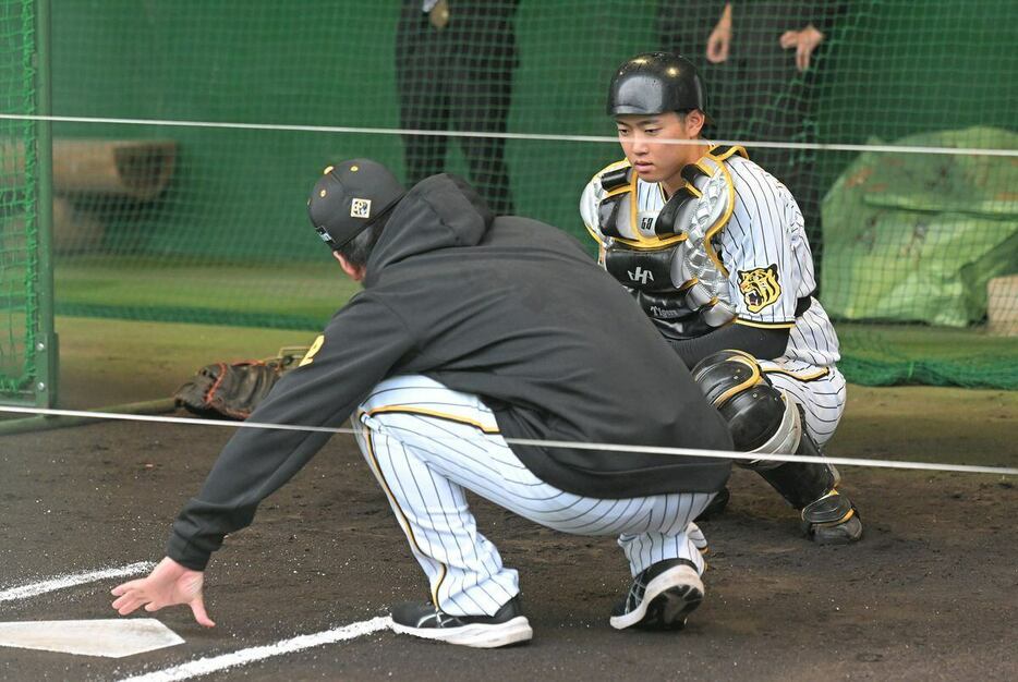 ブルペンで阪神・藤川球児監督から指導を受ける中川勇斗＝安芸市営球場（撮影・根本成）