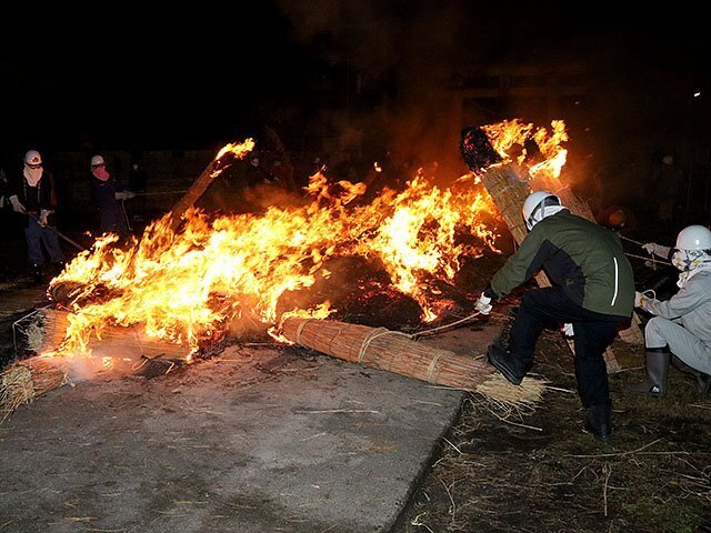 新治神社の参道ではたいまつが次々に燃やされた