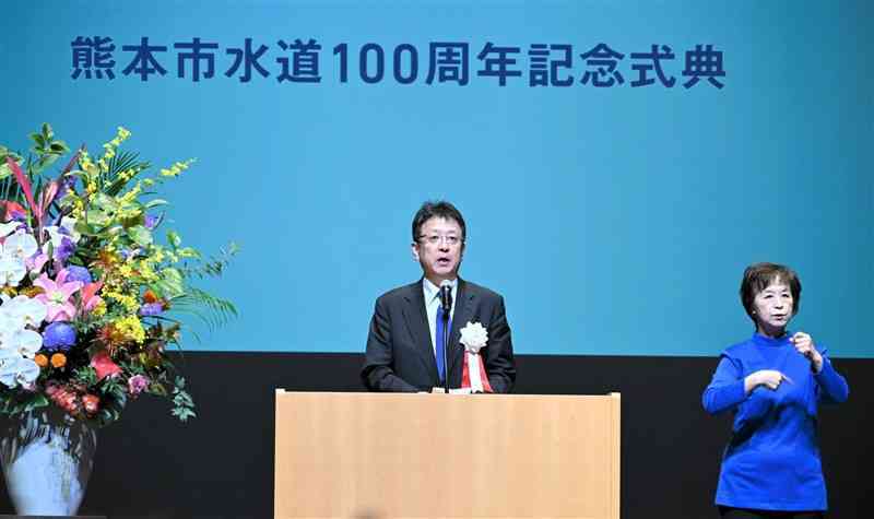 熊本市の水道事業100周年記念式典で、あいさつする大西一史市長（左）＝10日、中央区