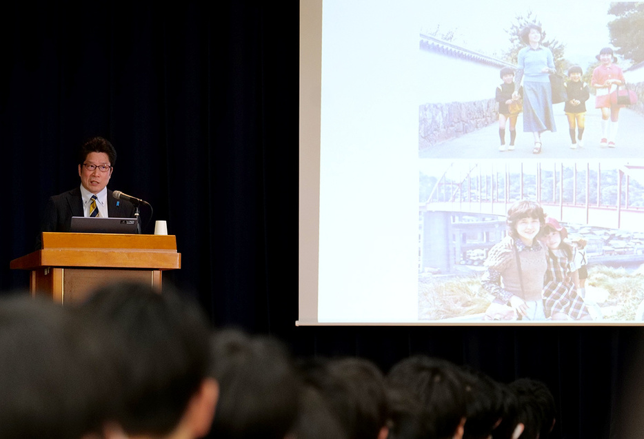 体育館に集まった生徒に向け、拉致問題について伝える拓也さん＝川崎市麻生区の市立王禅寺中央中学校