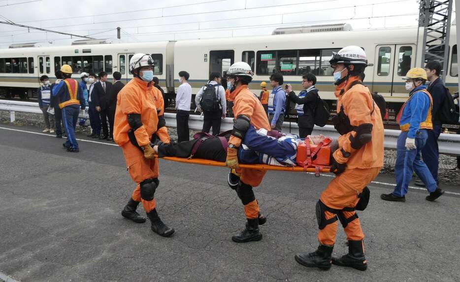 列車からけが人を搬送する訓練を行う参加者＝奈良市佐保台