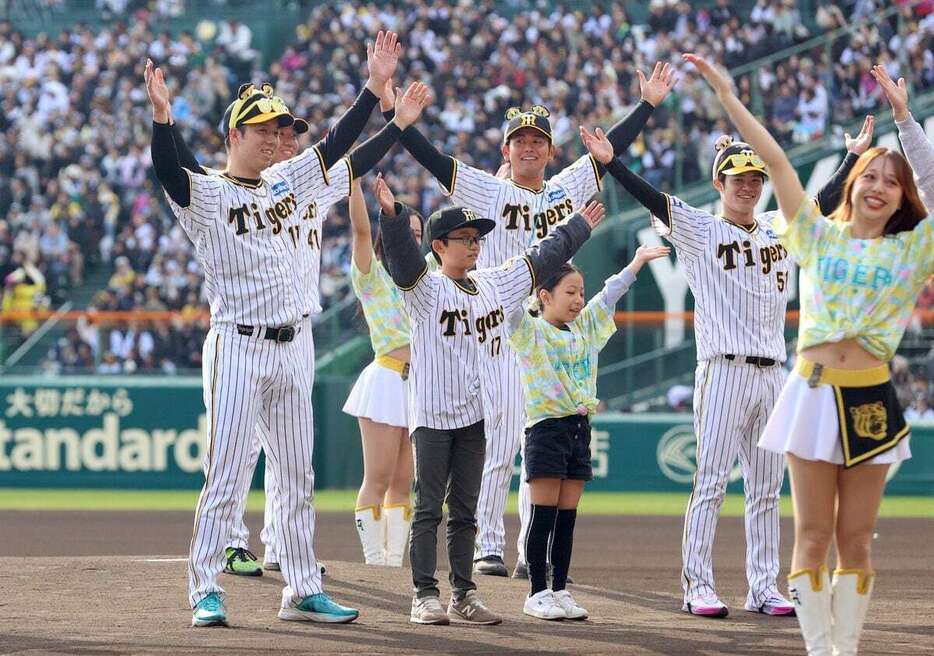 【プロ野球阪神　ファン感謝デー】　子どもと一緒にTORACOダンスを踊る阪神・青柳晃洋(左)らナイン＝甲子園球場（撮影・水島啓輔）