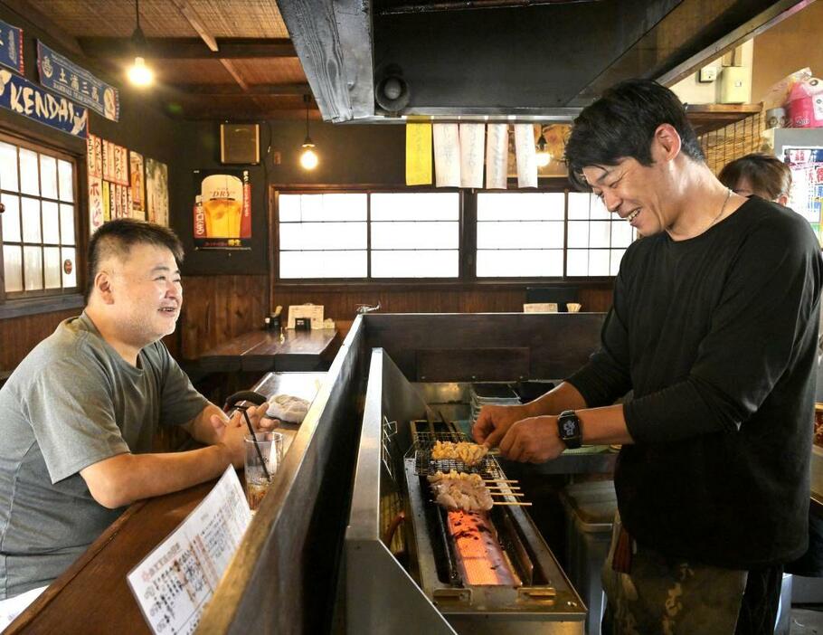 焼き鳥を焼きながら、前店主の佐藤貴嘉さん(左)と言葉を交わす現店主の長井健太さん=土浦市右籾、吉田雅宏撮影