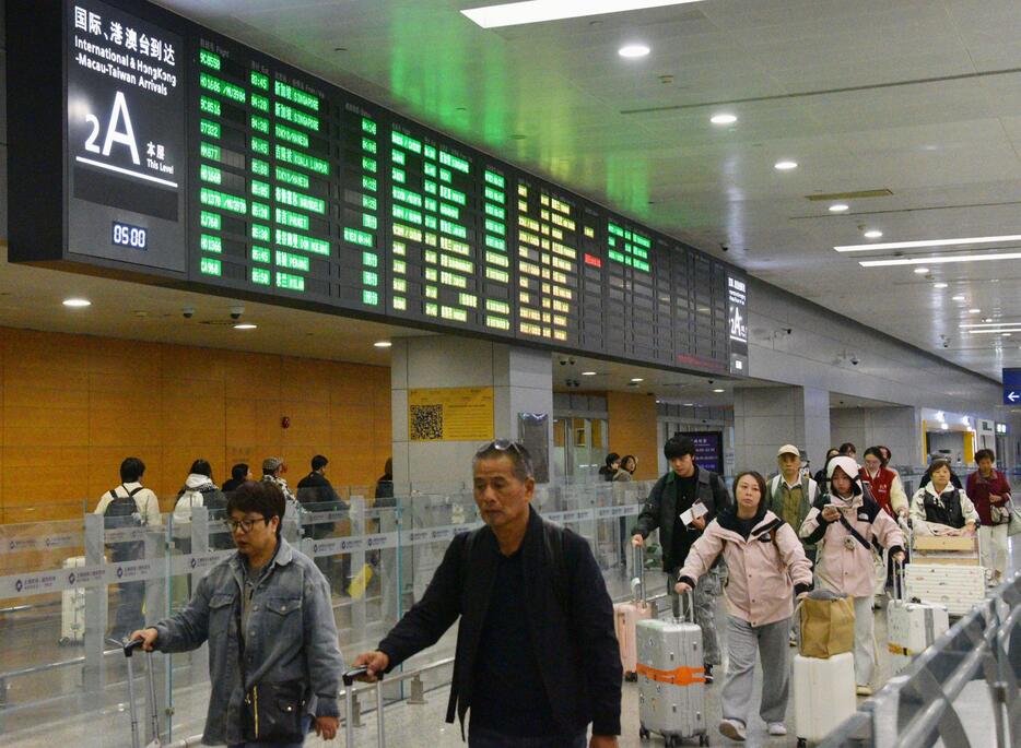 日本からの便で上海浦東国際空港に到着した乗客ら＝30日（共同）