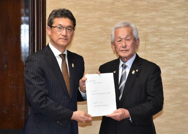 河野知事に要望書を手渡す県生活衛生同業組合連合会の岡崎富明会長（右）＝２２日午後、県庁