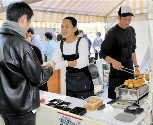 揚げたての油揚げを買い求める来場者=11月9日、福井県福井市のハピテラス