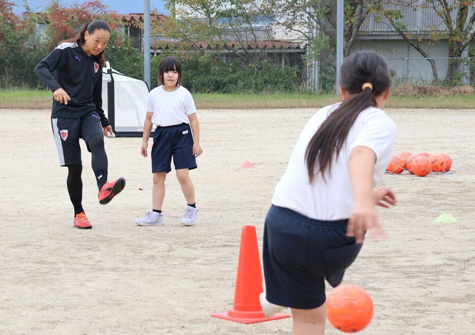 サンガのスクールコーチからパスの出し方を教わる児童（宮津市日置・日置小）