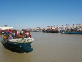 A Mitsui OSK Lines container ship sails near the Yangshan Deepwater Port in Shanghai. Photographer: Qilai Shen/Bloomberg