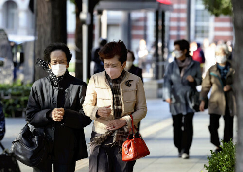 強い風が吹く中、寒そうに歩く人たち（７日、東京都千代田区で）＝横山就平撮影