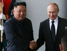 Kim Jong Un shaking hands with Vladimir Putin in 2019.