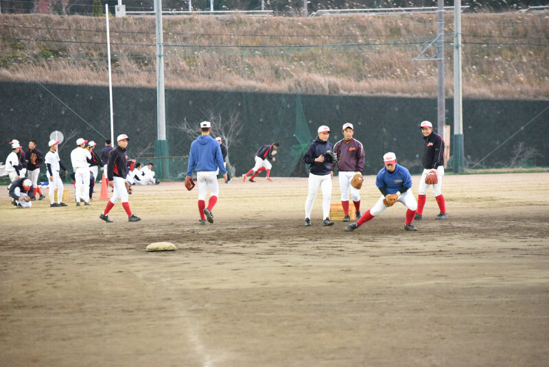 近大高専では2年生部員がノックを受ける後方で、1年生部員がダッシュに取り組む＝三重県名張市の同校グラウンドで2019年12月20日、鈴木英世撮影