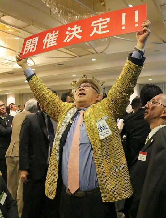［写真］2025年大阪万博開催決定を喜ぶ金ピカおじさん＝24日午前、大阪市北区で