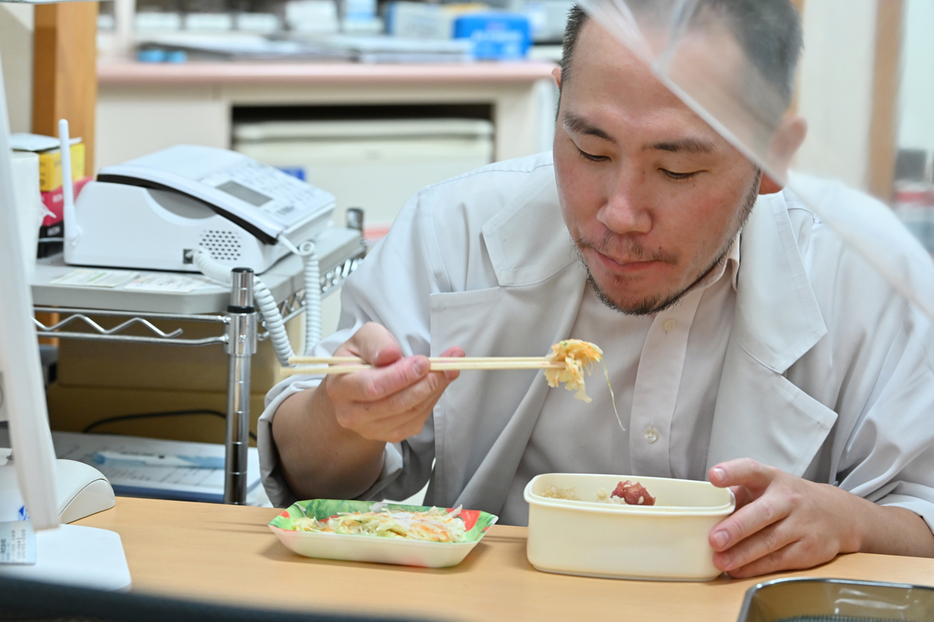 「昼食」をとるのは、客足が落ち着く午前3時半ごろ。この日のメニューは、日の丸弁当と割引のサラダ。「学生の頃と生活レベルが変わらない」と話す