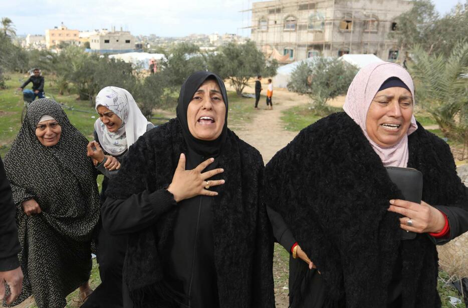 11日、イスラエルの攻撃を受けたパレスチナ自治区ガザで嘆き悲しむ住民（ゲッティ＝共同）