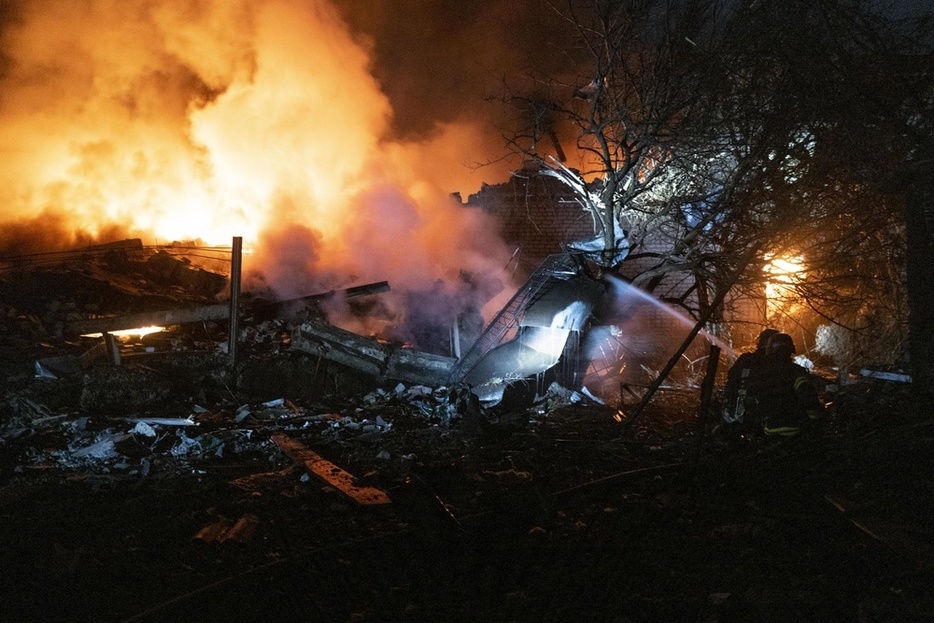 昨年11月、ウクライナ・ドネツク州ポクロフスクで、ロシア軍の砲撃で破壊された建物の消火活動に当たる消防隊員ら（ゲッティ＝共同）