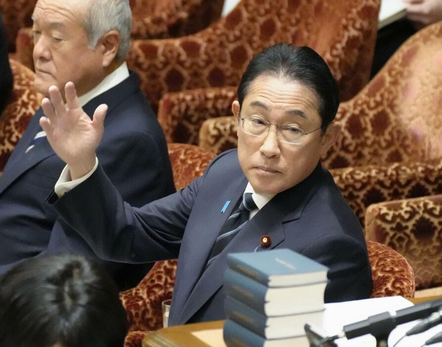 衆院予算委で答弁のため挙手する岸田首相＝24日午前