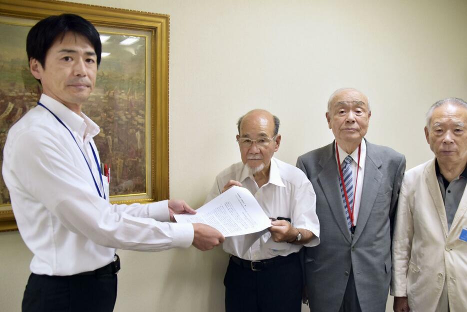都職員（左端）に要請書を手渡す宮川泰彦氏ら＝31日午後、東京都新宿区