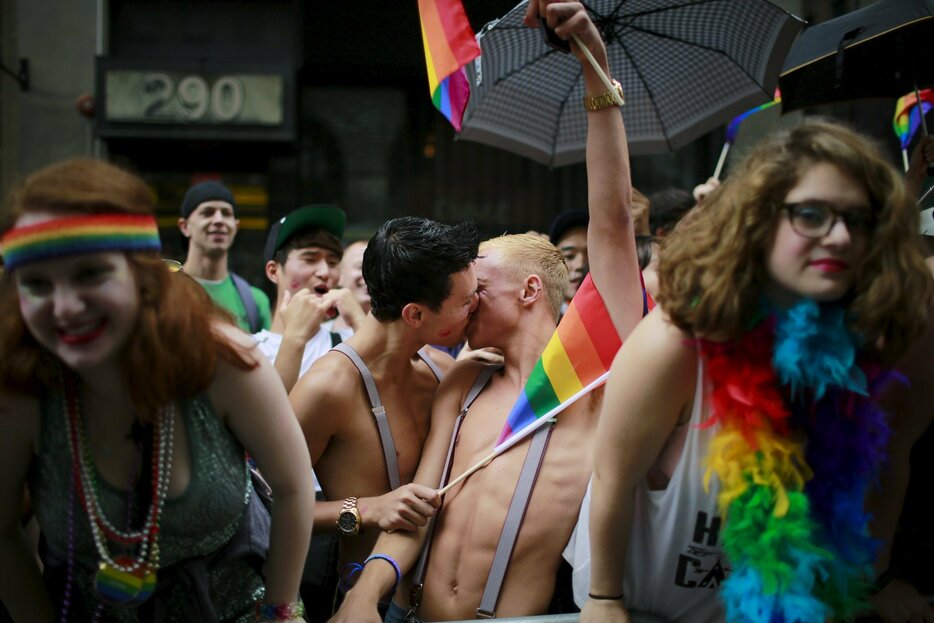 パレードの人波の中、キスをする2人＝2015年6月28日（写真：ロイター/アフロ）