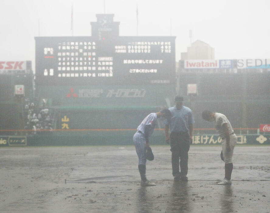 土砂降りの雨の中、球審が大阪桐蔭対東海大菅生戦の雨天コールドを宣言した。3点を追う東海大菅生の攻撃は8回一死一、二塁と続いていたのだが…(写真・日刊スポーツ／アフロ）