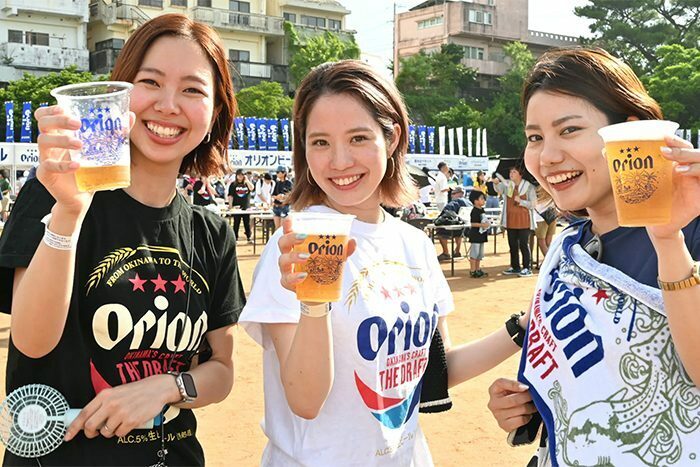 ビールを片手に音楽やエイサーを楽しむ来場者＝24日、沖縄市のコザ運動公園サブグラウンド