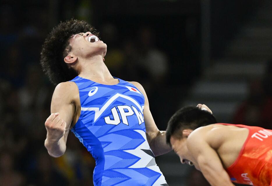 男子フリー65キロ級準決勝　モンゴル選手（右）を破り、雄たけびを上げる清岡幸大郎＝パリ（共同）