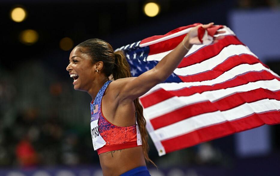 陸上女子200mを制し、星条旗を手に喜ぶガブリエル・トーマス＝6日、パリ郊外（ロイター＝共同）