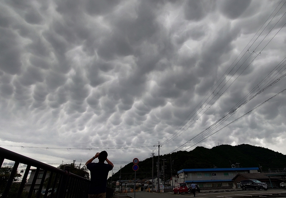 いくつものこぶが垂れ下がったように見える不気味な雲。「乳房雲」とみられる＝2024年8月28日午後4時8分、兵庫県丹波篠山市大沢で