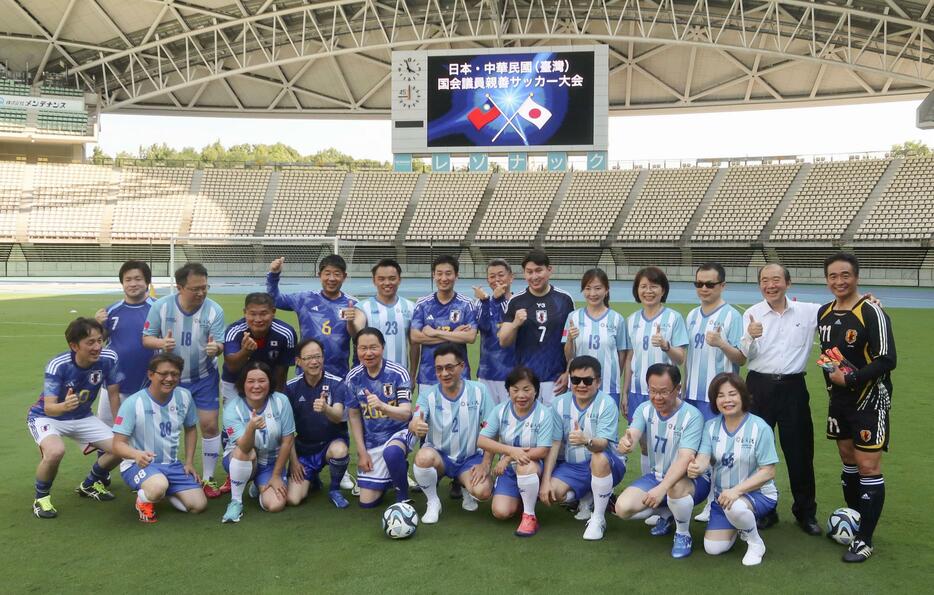 サッカーの親善試合前に記念撮影する日本と台湾の議員＝3日午後、大分市