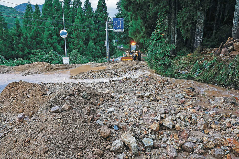 土砂で埋め尽くされた県道＝２５日午後６時、上市町下田