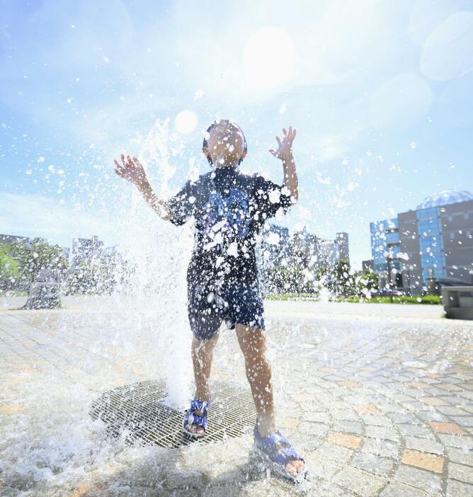 7月29日、厳しい暑さとなった浜松市内の公園で水遊びする男の子