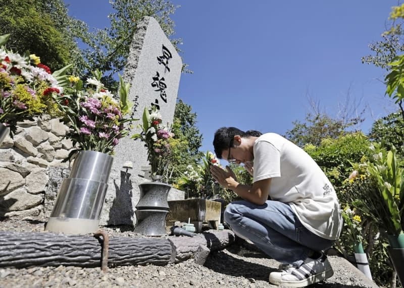 日航機が墜落した「御巣鷹の尾根」にある「昇魂之碑」で手を合わせる小林隼也さん＝２０２４年８月１２日、群馬県上野村