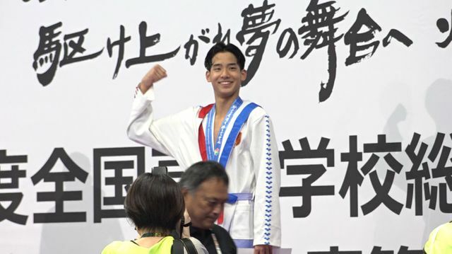 仲間からの声援に"力こぶポーズ"で応える村佐選手