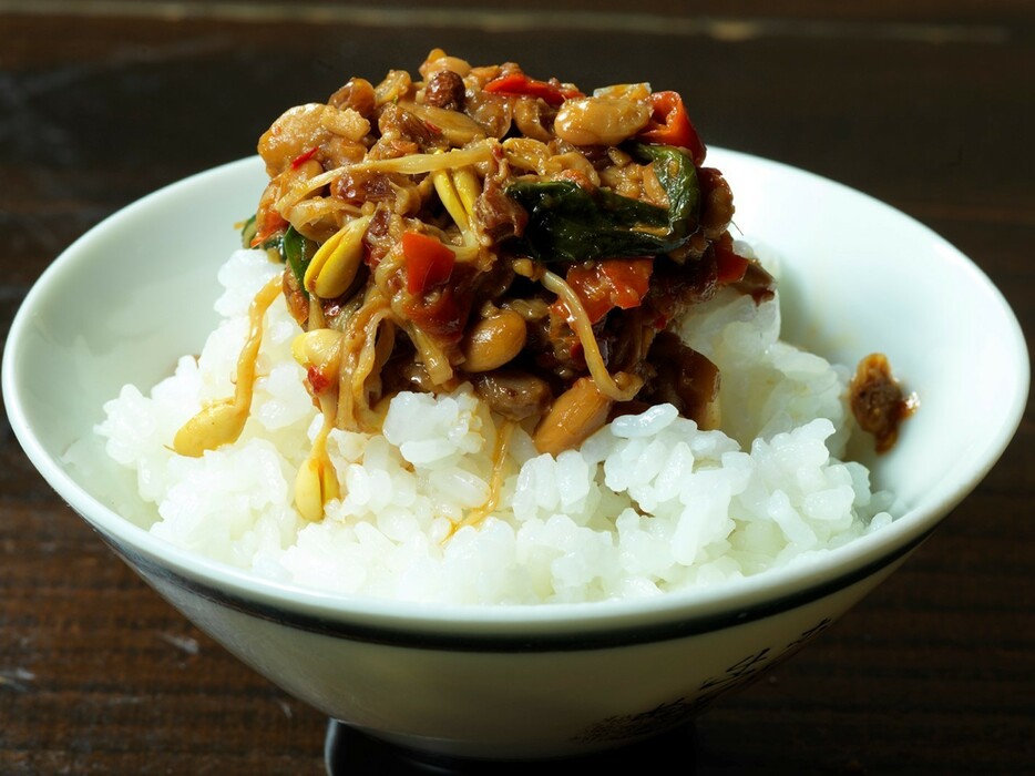 ▲ 穴あきおたまで鍋底の納豆や肉のカケラをすくい、ごはんへ。さらりと粘りのない納豆ごはんがうまい！