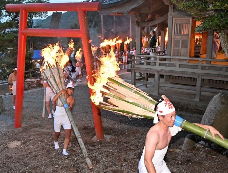 燃えさかる松明を担ぎ山頂を目指す若衆