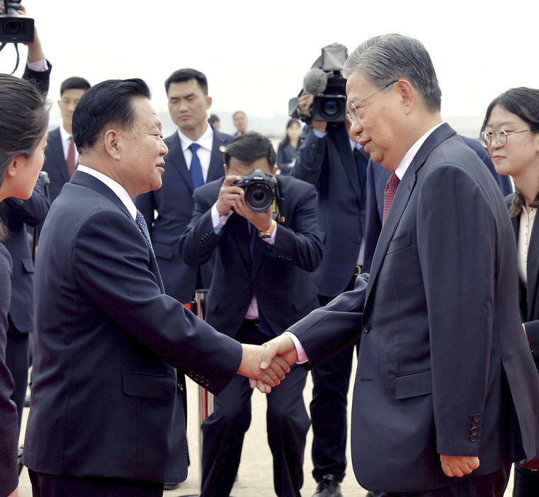 4月、空港に到着し北朝鮮の崔竜海最高人民会議常任委員長（左）の出迎えを受ける中国共産党序列3位の趙楽際氏＝平壌（共同）