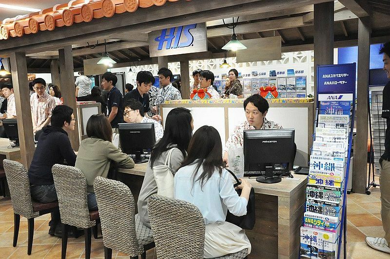 [写真]開店と同時に来店客が詰めかけ、スタッフと熱心に旅行プランを話し合っていた