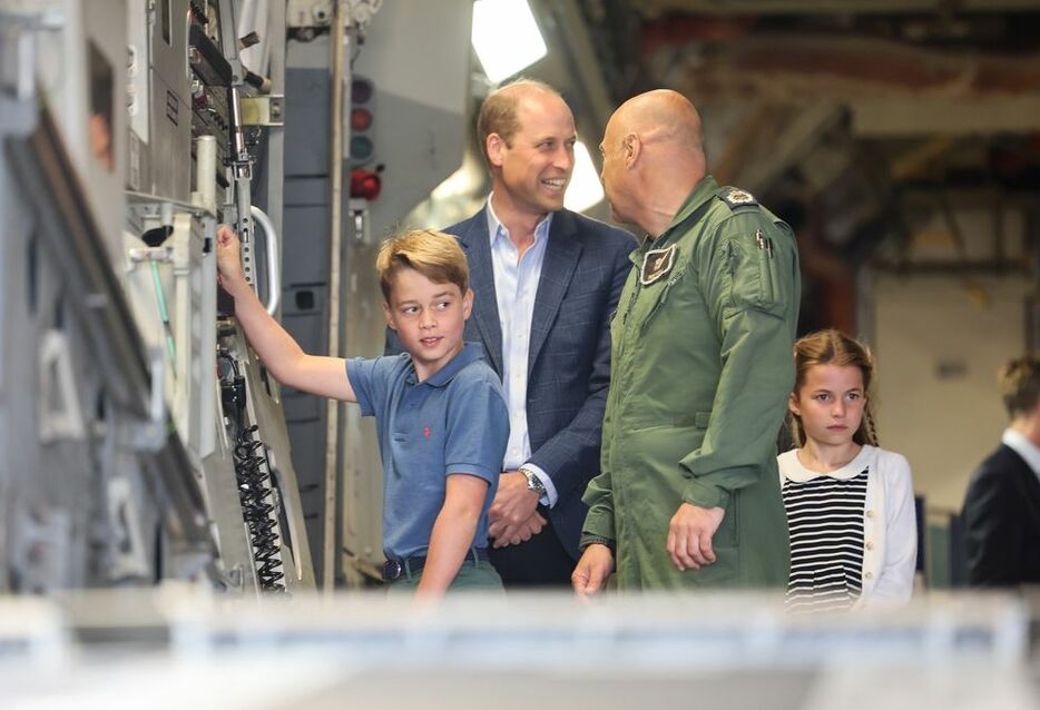 軍用長距離輸送機C-17の側で見学するジョージ王子