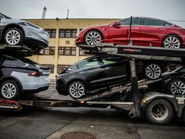 Tesla vehicles aboard a transporter truck at the Port of Oslo.