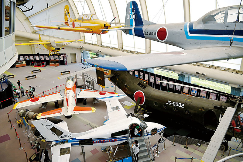 常設展示されている飛行機を囲むように「堀越二郎回顧展」のパネルやケースが壁側に並ぶ