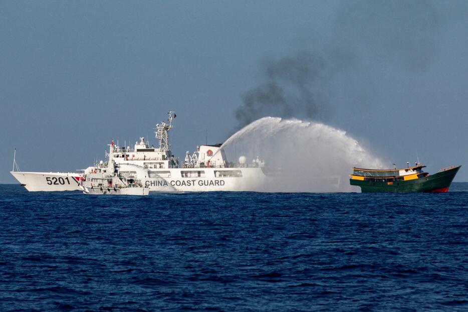 南シナ海のアユンギン礁で、フィリピンの補給船に放水する中国艦船＝3月5日（ロイター＝共同）