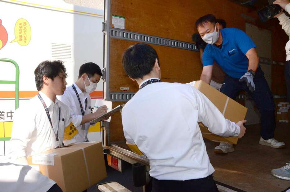投票用紙をトラックに積み込む県職員ら＝２９日、鹿児島県庁