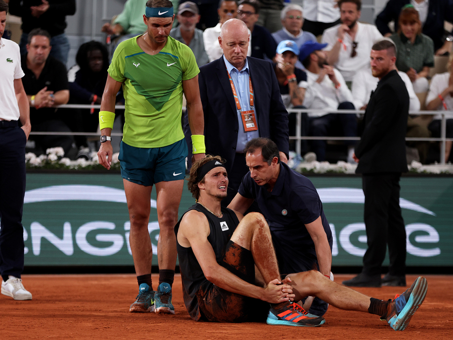 写真は2022年フレンチ・オープン（フランス・パリ）準決勝で足首を負傷したアレクサンダー・ズベレフ（ドイツ／手前）と心配そうに歩み寄るラファエル・ナダル（スペイン／中央左）（Getty Images）