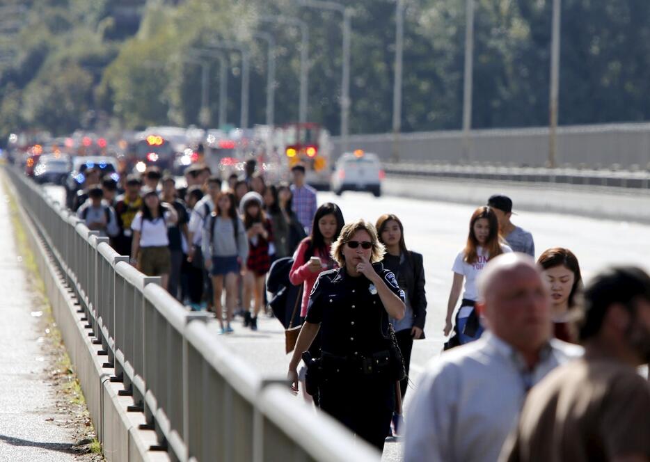 誘導される乗客。大型バスには留学生ら約45人が乗車していたという＝2015年9月24日（写真：ロイター/アフロ）