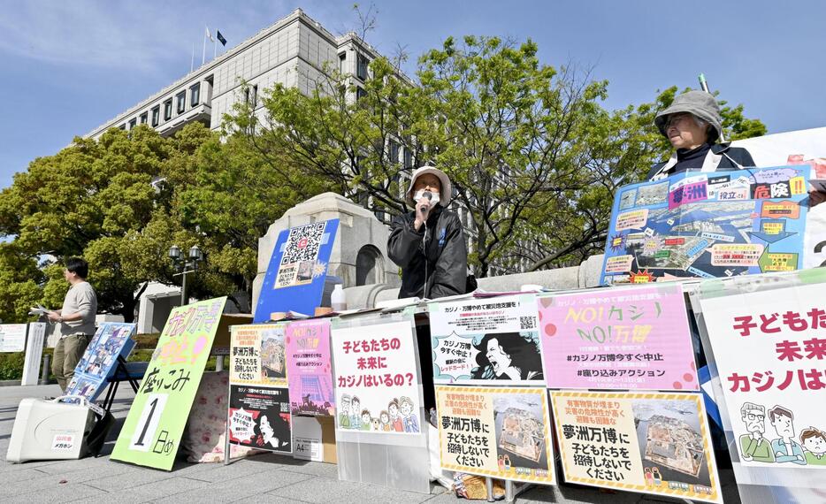 大阪市役所前で万博中止を訴える市民団体のメンバーら＝10日午後