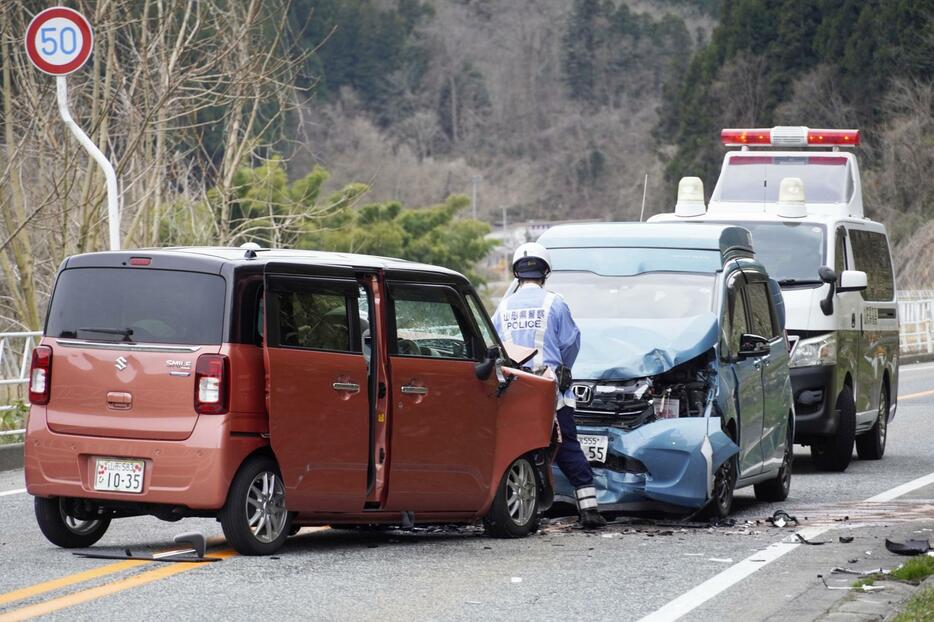 国道348号で正面衝突した軽乗用車（手前）と乗用車＝8日午後、山形県白鷹町